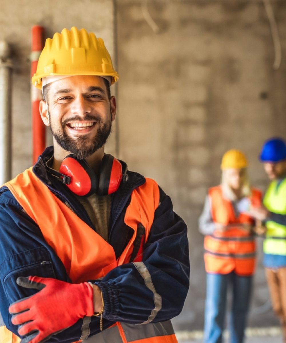 Construction,Site,Manager,Standing,Wearing,Safety,Vest,And,Helmet,,Thinking